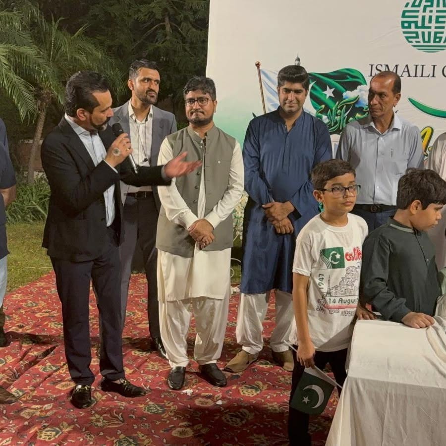 Tahir Javed stands with community members and children at an Ismaili CIVIC Independence Day event.