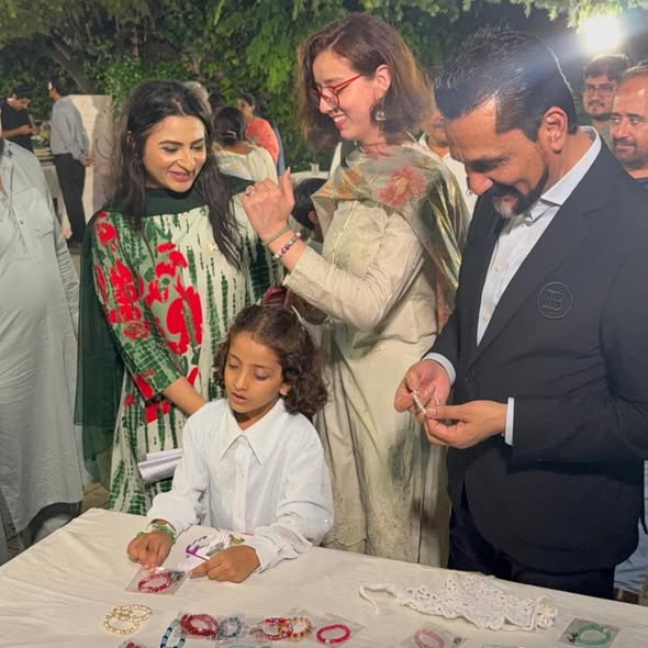 Tahir Javed participates in a Pakistan Independence Day celebration with community members and children.